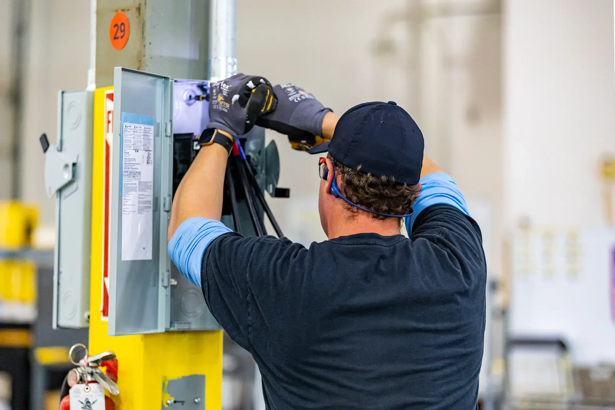 Electrician installing industrial disconnect switch