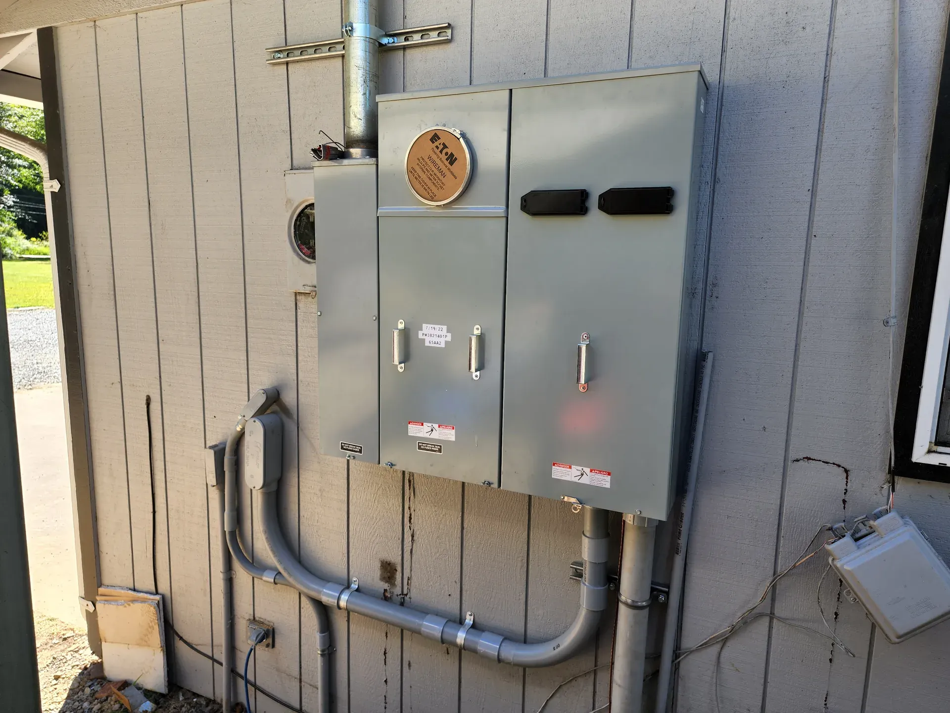 Exterior electrical panel and conduit for residential hot tub wiring
