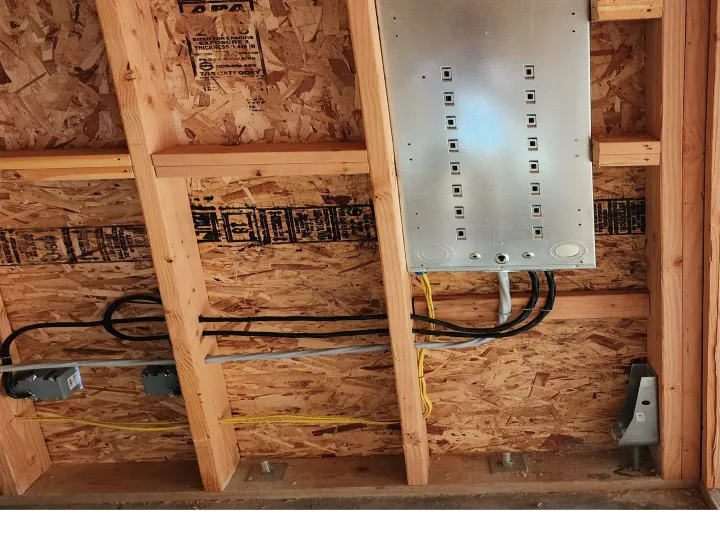 Phase 3 Electric electrician working on home remodel wiring during new construction framing