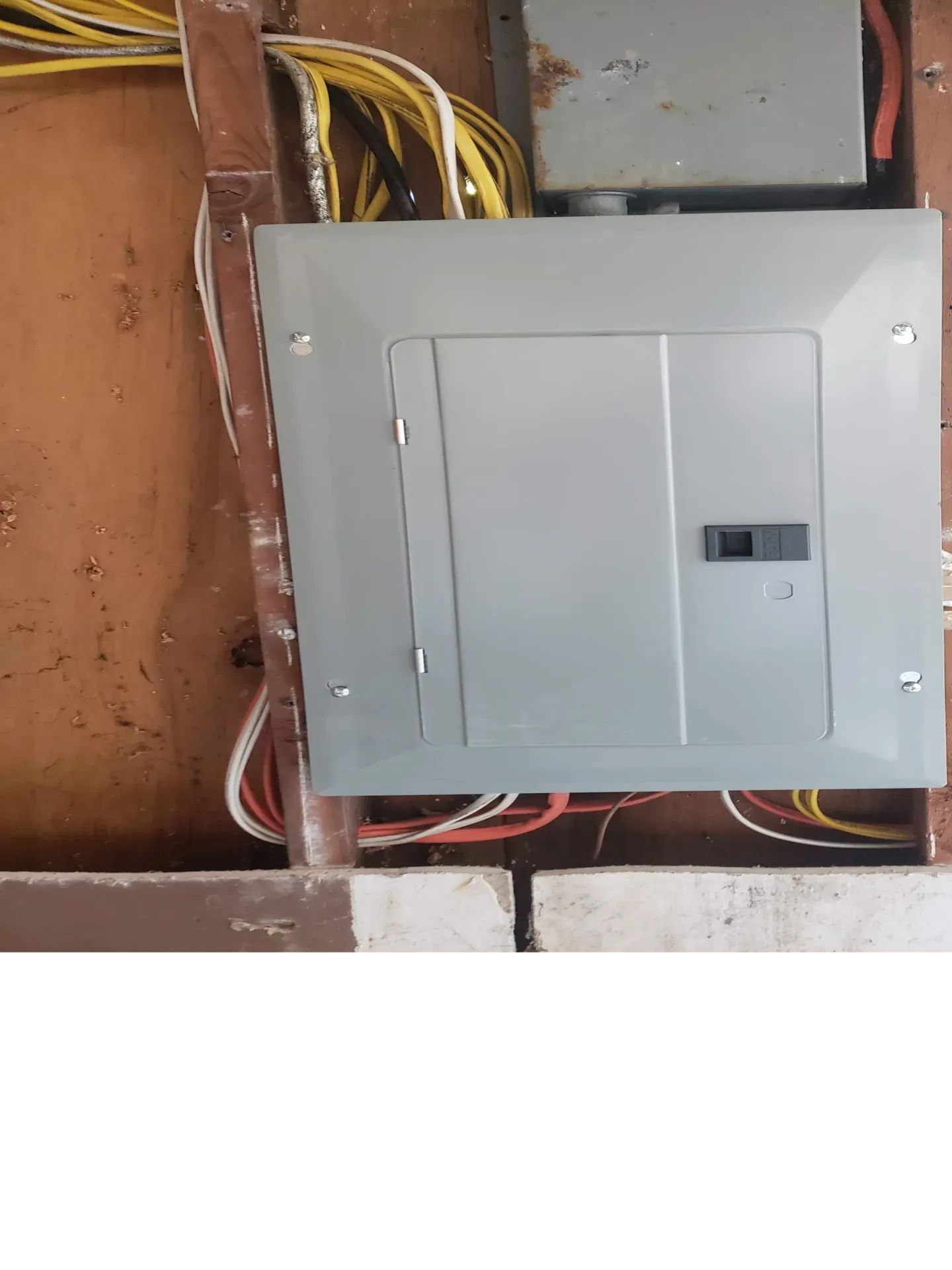 Open wall showing rough-in wiring during electrical panel replacement for home remodel