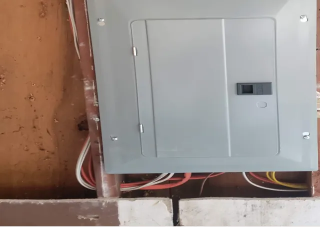 Open wall showing rough-in wiring during electrical panel replacement for home remodel