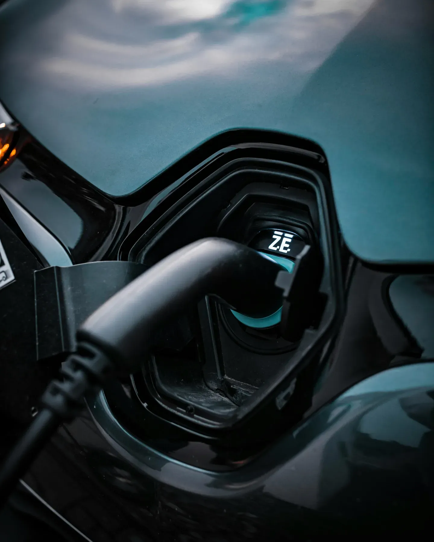 Electric vehicle plugged into a slow Level 1 charger in a residential garage