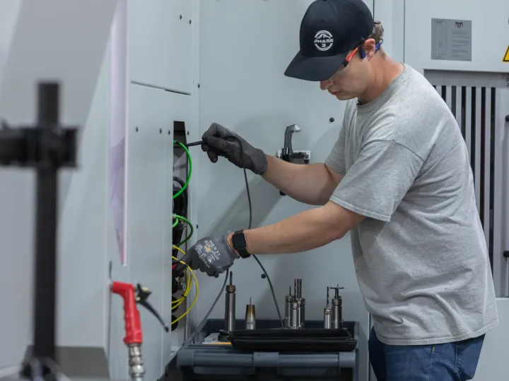 Industrial CNC machine electrical hookup and wiring in manufacturing facility, Snohomish County