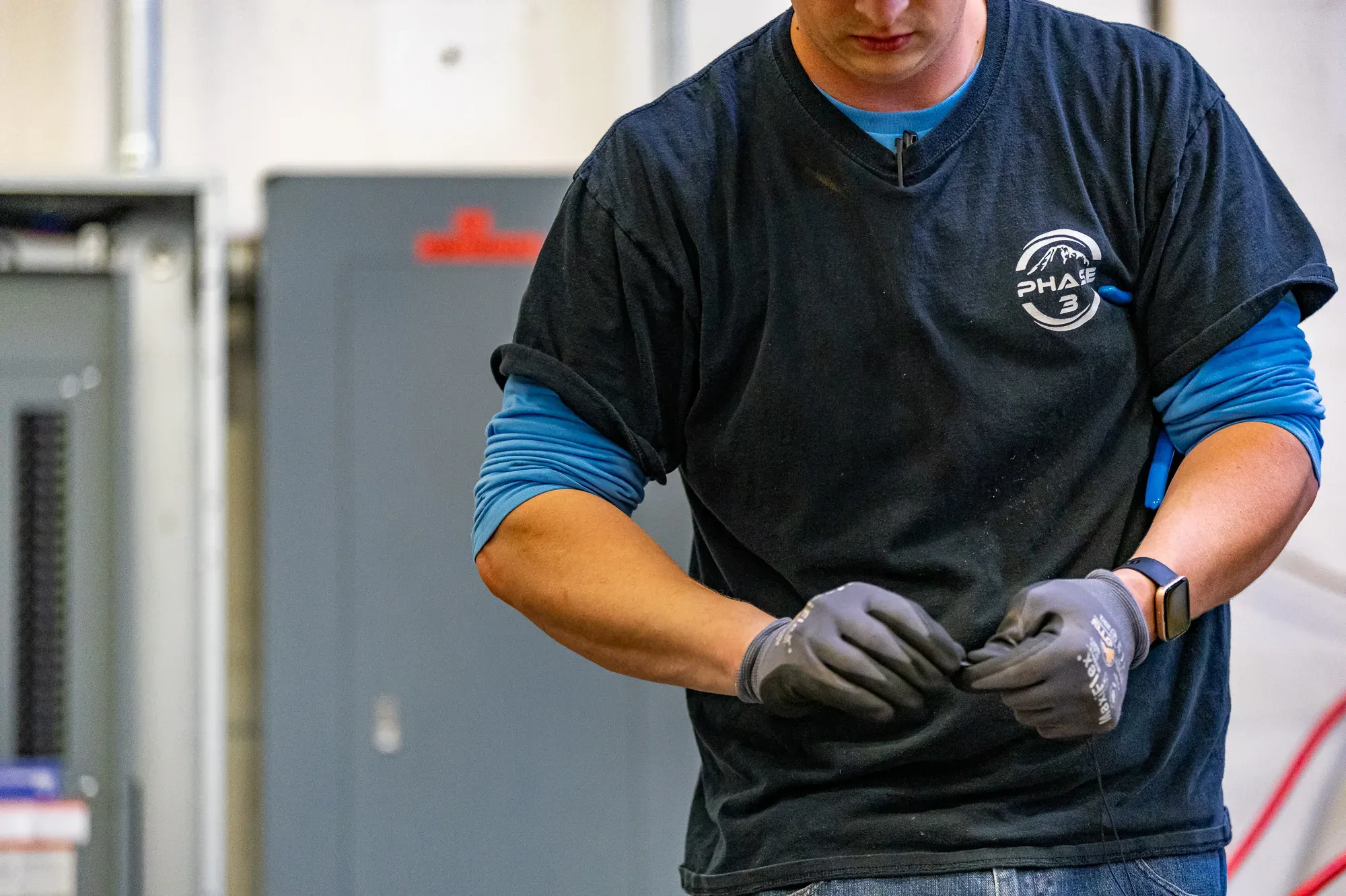 Phase 3 Electric technician preparing safety gear for electrical safety installation