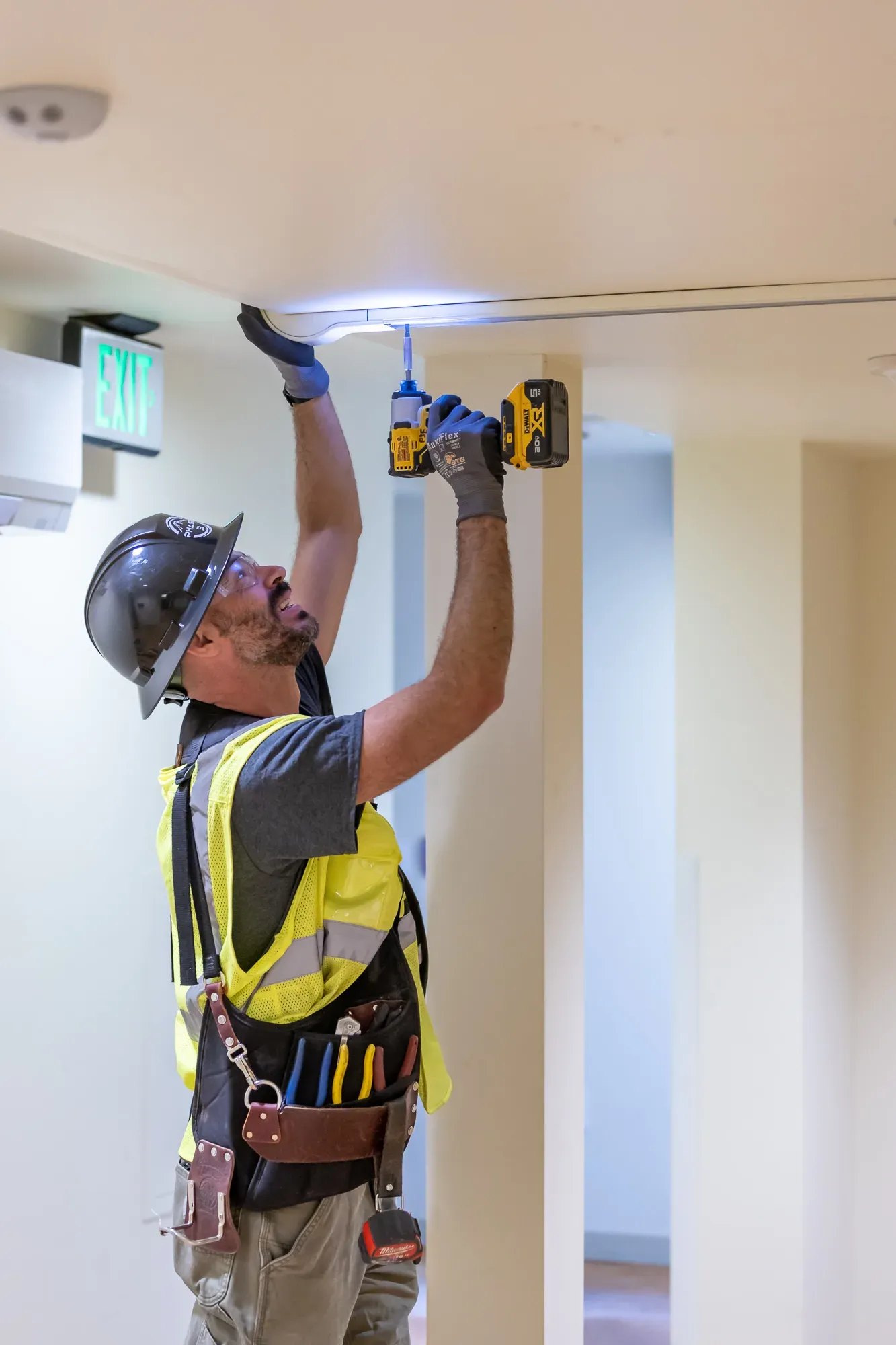 Phase 3 Electric technician installing commercial lighting in Woodinville, WA