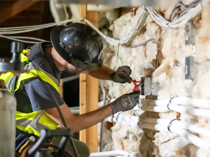 Phase 3 electrician working on residential wiring during home rewiring project