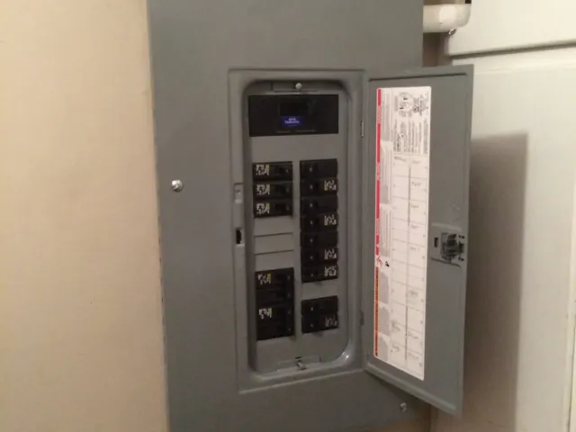 Old residential electrical panel with circuit breakers that needs upgrading