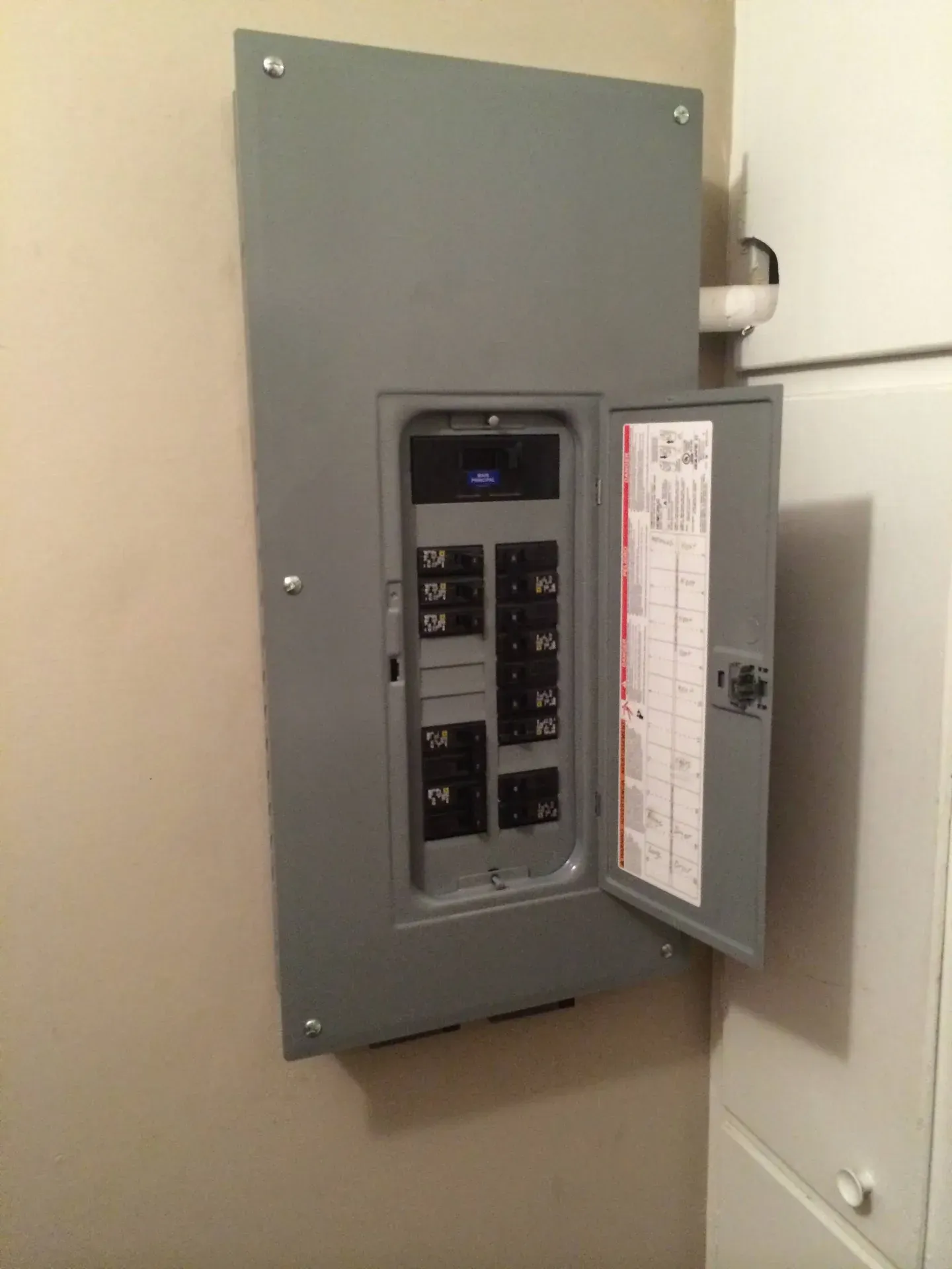 Old residential electrical panel with circuit breakers that needs upgrading