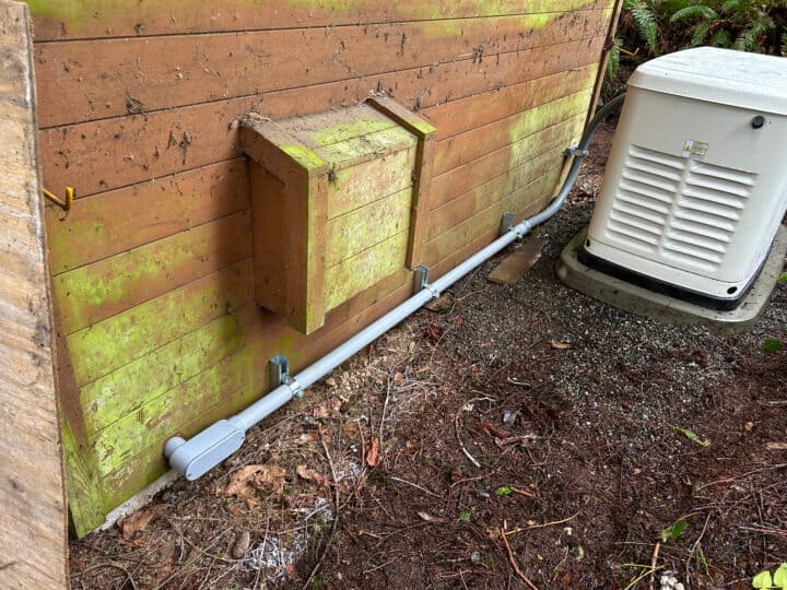 Exterior wall with electrical conduit and equipment.